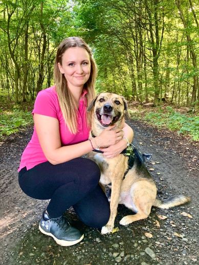 Laura Murza mit Hund auf einem Waldweg